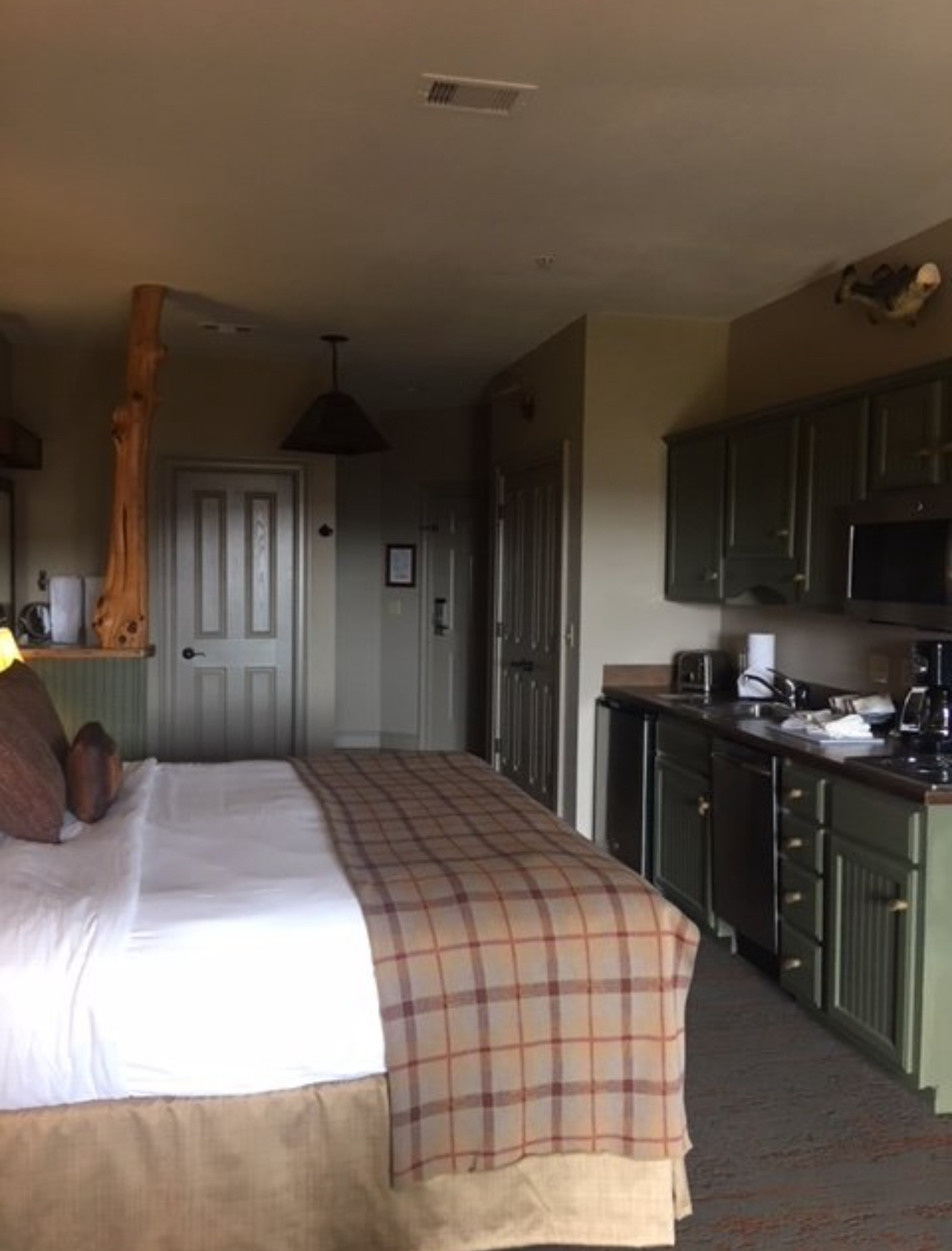 B Suite — Standard room with queen bed, espresso station, and mountain-view balcony. Comfortable yet efficient layout.